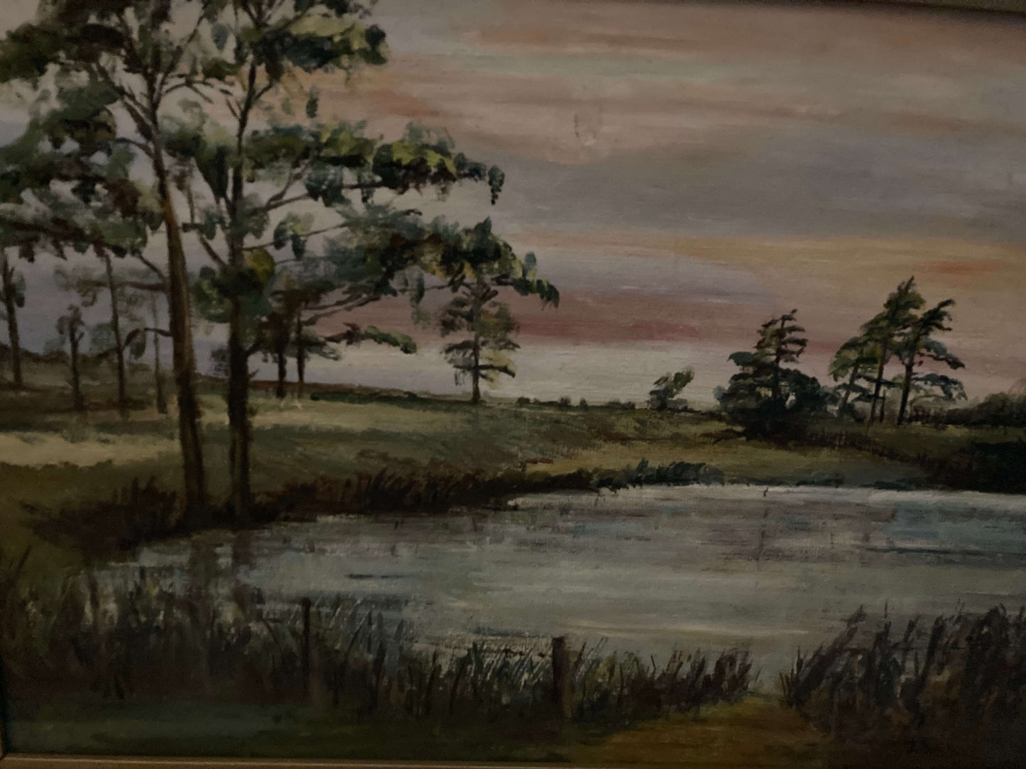 Landscape painting of a lake with trees and a sunset sky