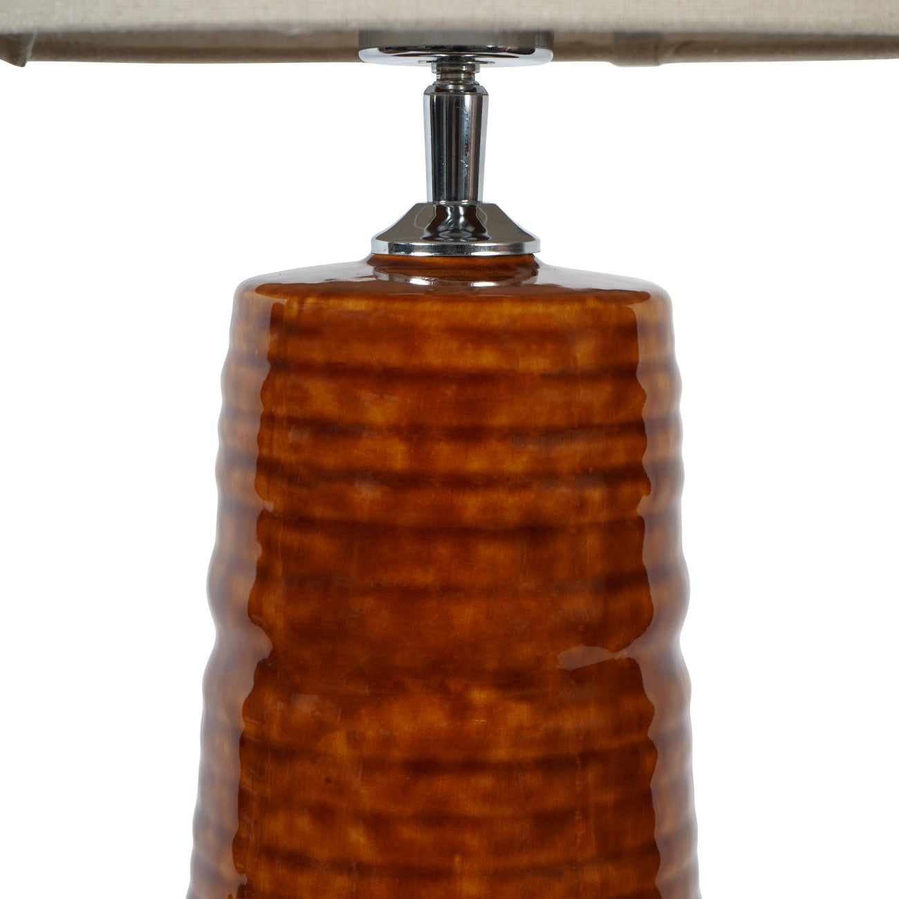Close-up of a brown textured lamp base with a metallic fitting on a white background