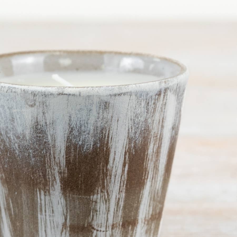 Close-up of a ceramic mug with a textured surface on a blurred background